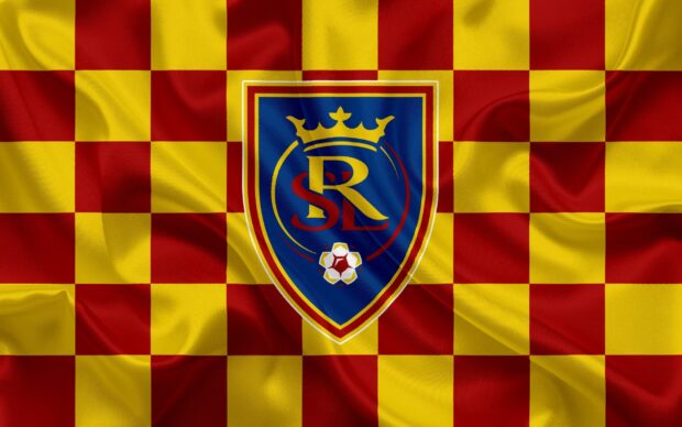 The Real Salt Lake emblem on a red and yellow checkered flag pattern