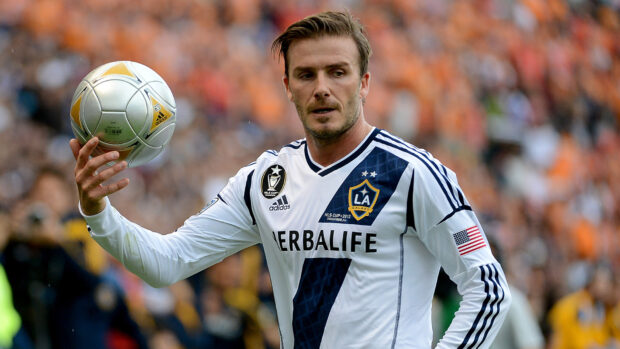 A soccer player holding a ball during an mls match