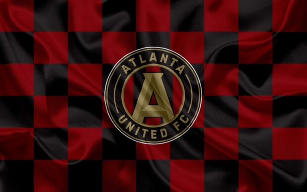 Atlanta united fc emblem on red and black checkered fabric texture