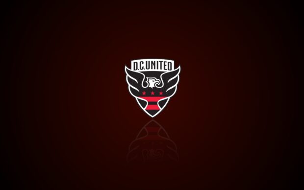 Dc United logo with eagle wings and red stars on dark background