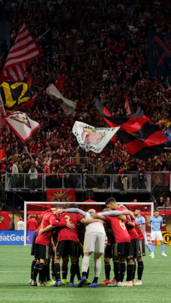 A soccer team huddle showing players unity before a Major League Soccer match