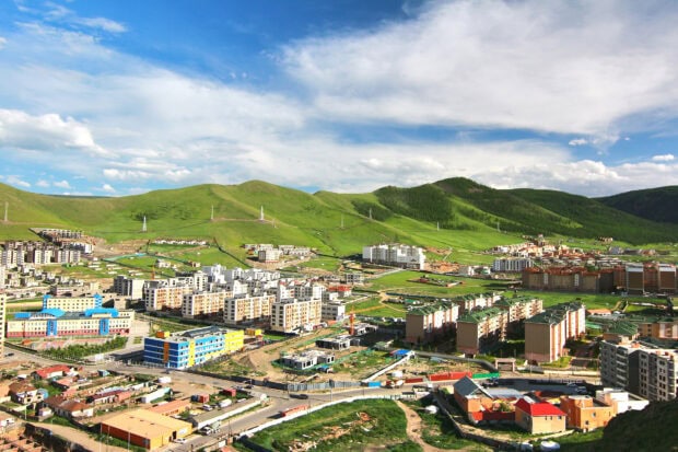 Scenic landscape of green hills and urban buildings in Mongolia city