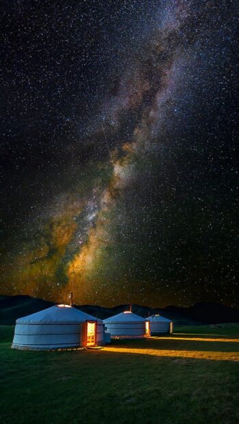Traditional Mongolia night sky with gers camping under starry sky