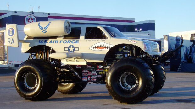A monster truck decorated with U.S Air Force logos parked outdoors in daylight