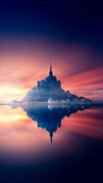 Mont Saint Michel island with its abbey reflected on calm water at sunset