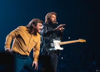 Morgan Wallen Wallpaper 2K Desktop Morgan Wallen and a fellow musician performing on stage during a live concert with a guitar and microphone