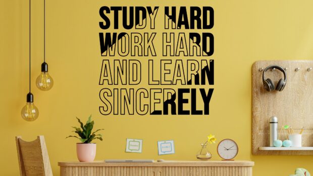 Motivational phrase study hard work hard and learn sincerely on yellow wall in study room