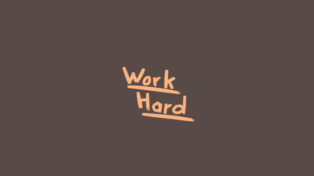 Motivational phrase work hard centered on a plain background