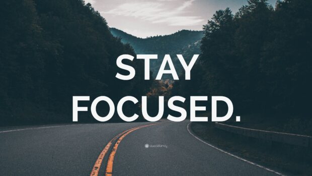 Stay focused road with mountains and trees in the background motivational quote