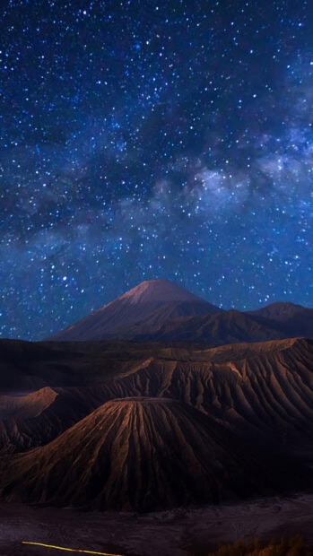 Stunning night sky above Mount Bromo volcanic landscape with stars and Milky Way visible