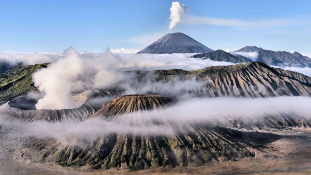 Smoking volcanic mountain with beautiful fog at Mount Bromo in Indonesia