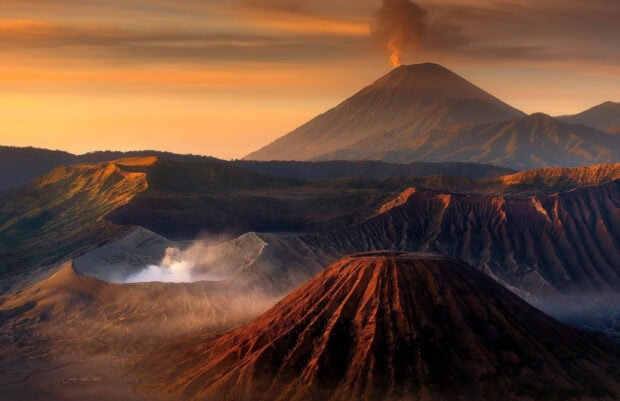 Smoking volcano at Mount Bromo with a breathtaking sunset view