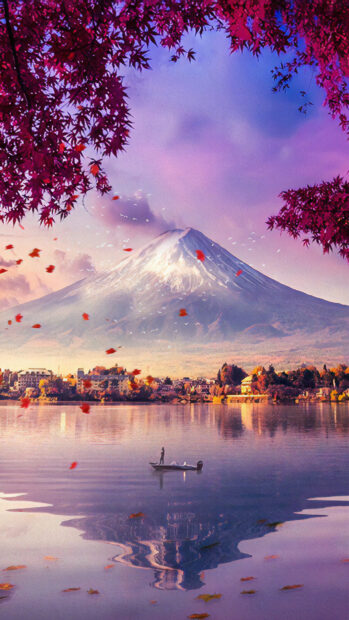 Serene view of Mount Fuji reflected on the lake with autumn leaves and a boat floating nearby