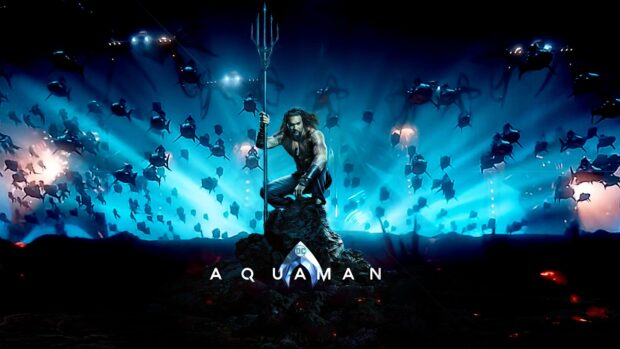 Aquaman character holding a trident on a rock surrounded by aquatic creatures in a deep underwater scene