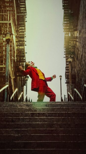 Joker character dancing on city stairs in vibrant red suit