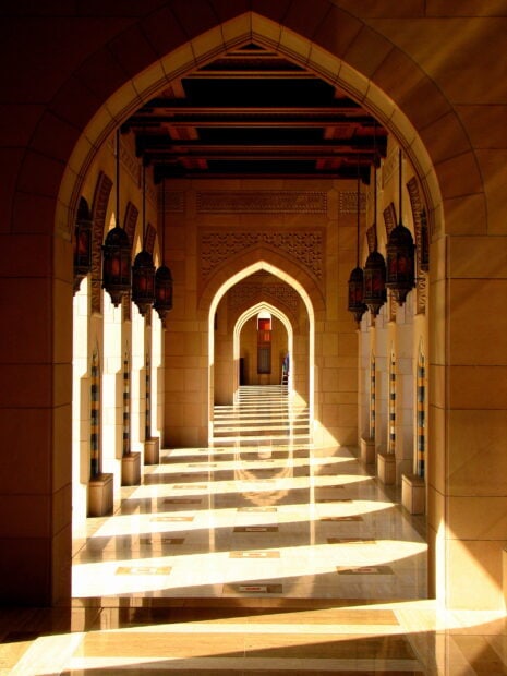 The traditional architectural arches in Muscat Oman hallway illuminated by sunlight