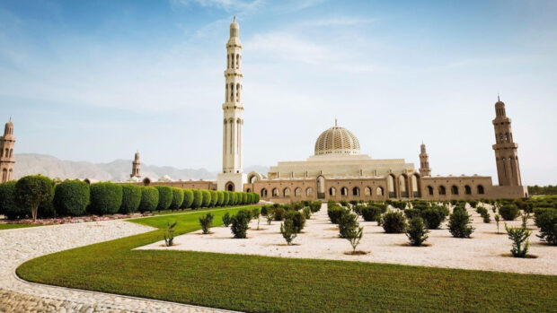 Beautiful Muscat Oman architecture with landscaped gardens and clear sky
