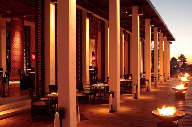 Cozy restaurant terrace in Muscat Oman with warm lighting and fire bowls