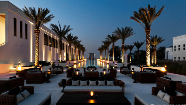 Luxury outdoor seating area with palm trees in Muscat Oman at dusk