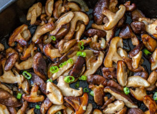 Sautéed mushrooms with green onions cooked to perfection in a pan