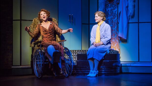 A theatrical scene showing musical performers expressing emotion during a stage performance