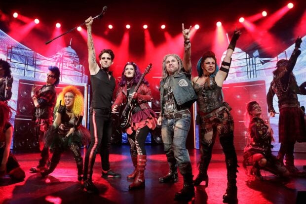 Rock band performance with vibrant costumes and energetic stage presence