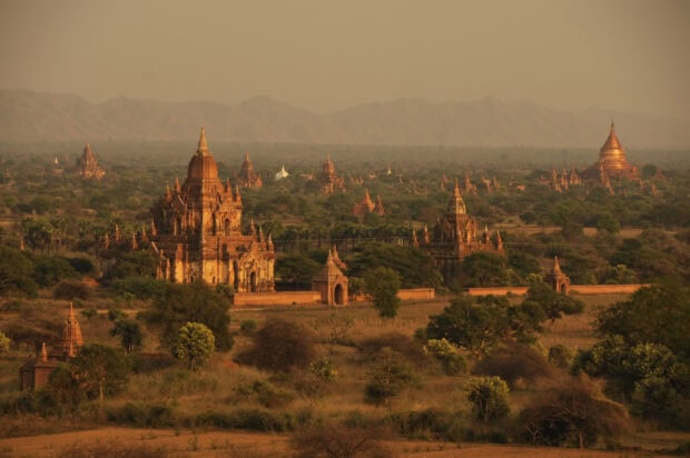 Ancient temples and pagodas surrounded by greenery in Myanmar landscape