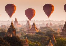 Hot air balloons flying over ancient temples in Myanmar scenic landscape