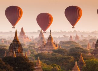 Hot air balloons flying over ancient temples in Myanmar scenic landscape