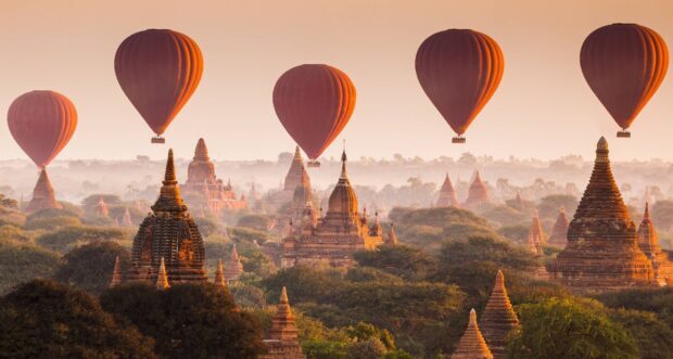 Hot air balloons flying over ancient temples in Myanmar scenic landscape