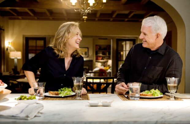 A cheerful couple enjoying a meal together in a cozy dining room setting