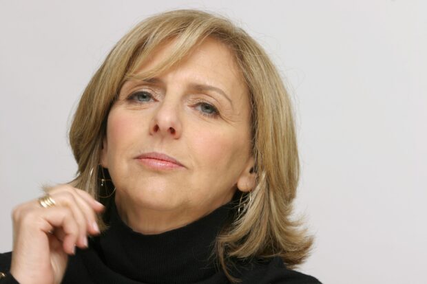 Close up of Nancy Meyers wearing black sweater and gold hoop earrings
