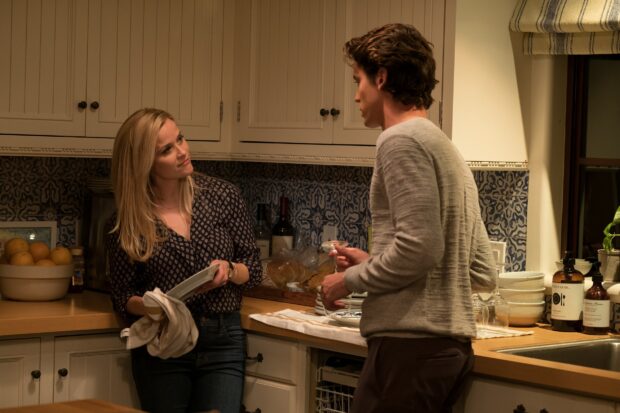 A woman and a man having a conversation in a kitchen setting