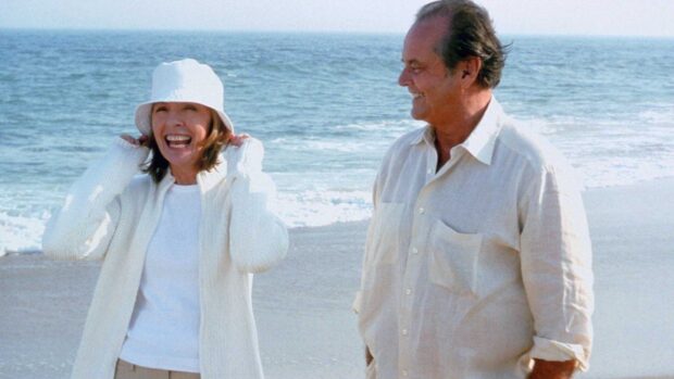 A joyful moment with Nancy Meyers walking on the beach with a man in casual clothes