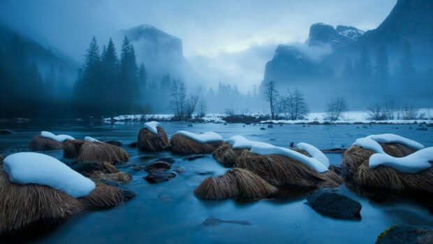 Winter landscape with snowy grass and river in a National Geographic scene