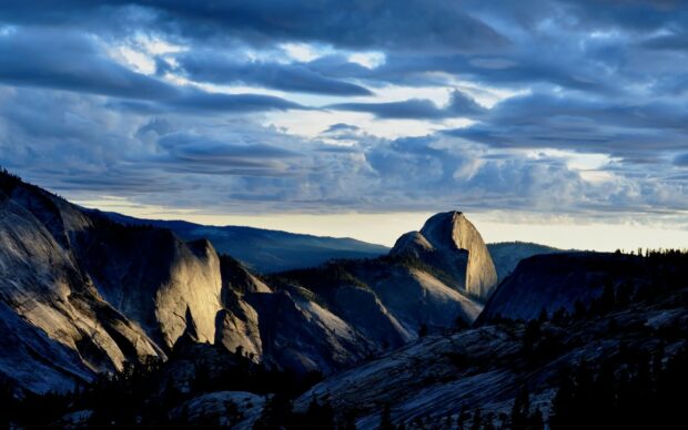 Granite rock formations and dramatic clouds at sunset in a natural landscape