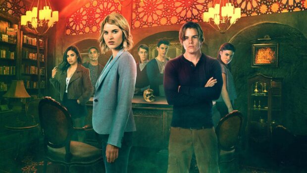 Group of young adults from a Netflix series standing in a mysterious room with books and antique decor