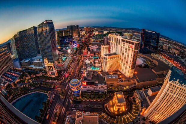 A vibrant aerial view of Nevada cityscape with illuminated buildings and streets at dusk