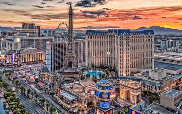 The famous Nevada cityscape with iconic landmarks and a colorful sunset sky in the background