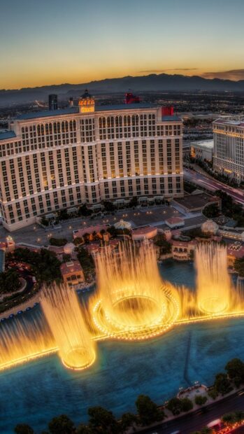Bellagio fountains in Nevada with mountain backdrop at sunset showing vibrant water display