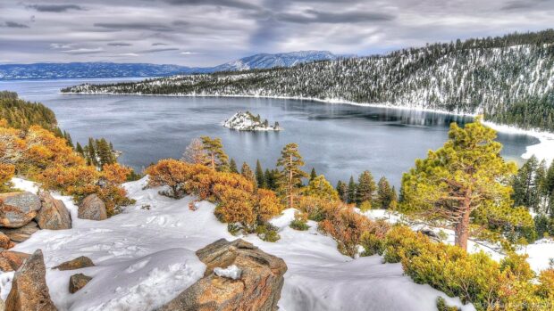 Snow covered rocks and colorful trees surrounding Nevada lake landscape