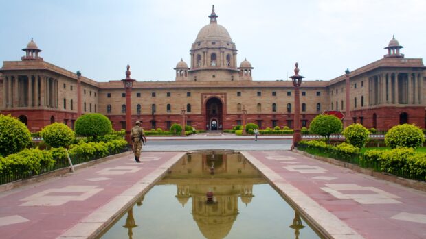 The architecture of New Delhi government building with reflective pool in front of it