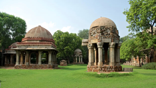 Ancient architecture in New Delhi surrounded by greenery and blue sky