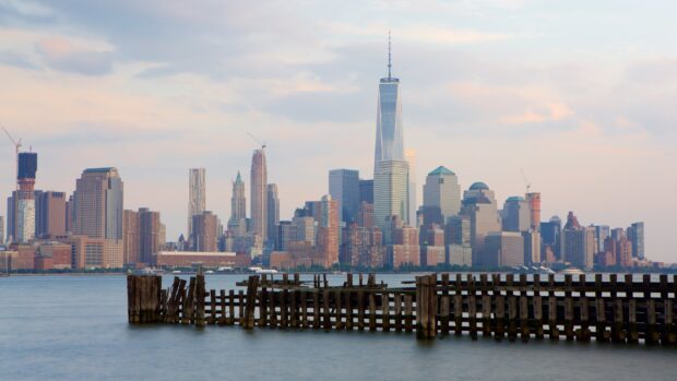 A scenic view of New Jersey skyline with wooden pier in the foreground at sunset