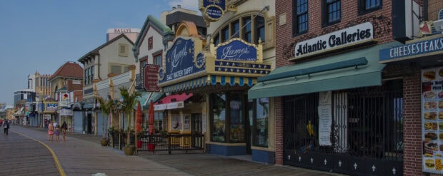 The New Jersey boardwalk with shops and people enjoying a sunny day