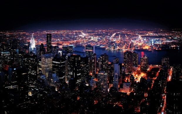 New York city skyline at night with bright lights and illuminated buildings