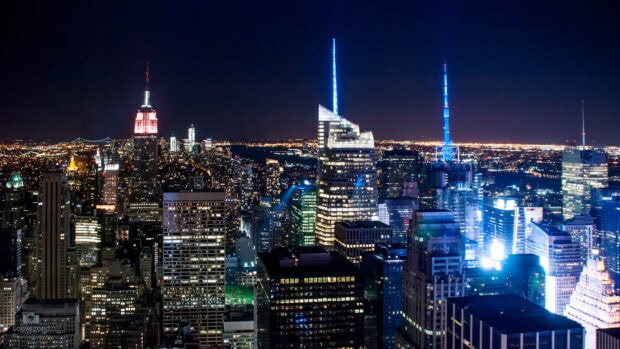 New York city skyline at night with illuminated skyscrapers and vibrant lights