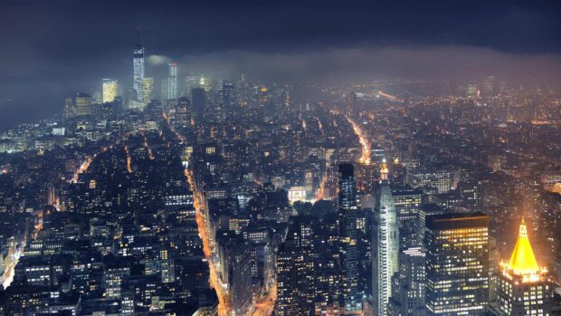 A breathtaking view of New York skyline at night with illuminated streets and buildings in high resolution