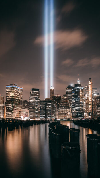 New York skyline at night with tribute lights shining above the cityscape