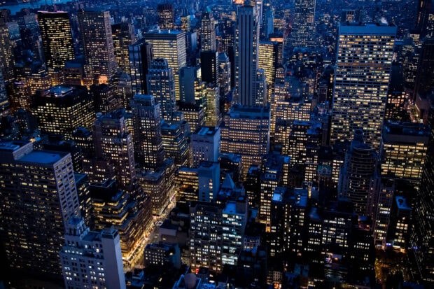 Night view of New York city skyscrapers with lights illuminating the skyline